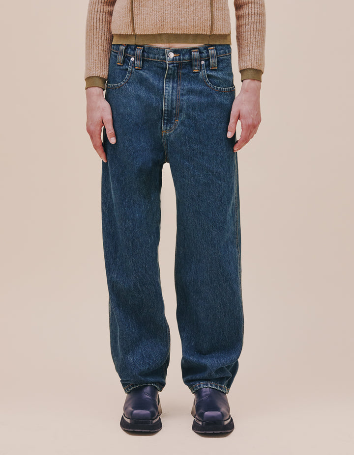 Our classic baggy jean is updated in our “New Blue” enzyme wash with over-dyed indigo. Includes signature back pockets and nickel hardware. The jeans are distinguished with our trademark back pockets that are exaggerated in scale with a carpenter's hammer loop on the back left pocket. They have a zip fly closure with a logo shank on the waistband and rivets on the front pockets in nickel hardware. Models wear sizes 27 and 30. Made in USA. 100% cotton.