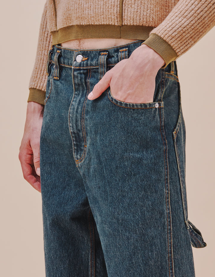 Our classic baggy jean is updated in our “New Blue” enzyme wash with over-dyed indigo. Includes signature back pockets and nickel hardware. The jeans are distinguished with our trademark back pockets that are exaggerated in scale with a carpenter's hammer loop on the back left pocket. They have a zip fly closure with a logo shank on the waistband and rivets on the front pockets in nickel hardware. Models wear sizes 27 and 30. Made in USA. 100% cotton.