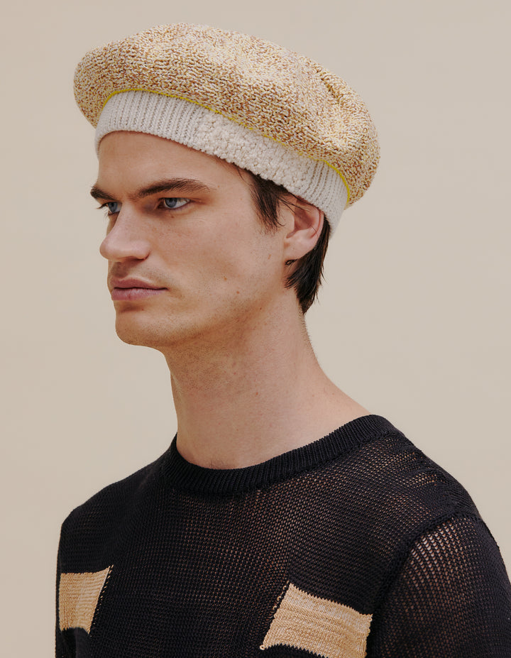 Fully fashioned knit beret made from a cotton and linen yarn blend. Contrast ribbed white band. Model wears OS. 49% cotton, 49% linen, 2% poly. Made in China.