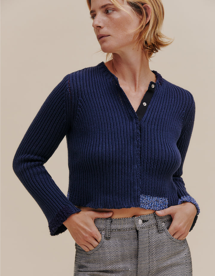 Ribbed cardigan made from a cotton and linen yarn blend. Contrasting color patches around hem, neckline and cuff. Finished with a snap front placket. Model wears size S. 49% cotton, 49% linen, 2% poly. Made in China.