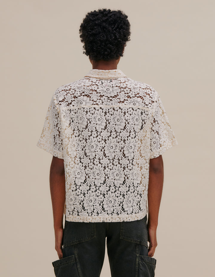 Italian floral lace boxy-fit short sleeve button down. Detailed with exaggerated collar points and two patch pockets at the chest. Models wear size M. 55% cotton, 27% nylon, 18% viscose. Made in China.