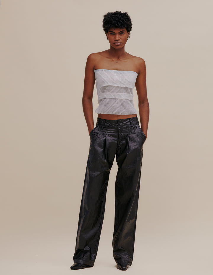 Pleated wide leg pant made from an Italian coated nylon with a high sheen. Unlined, with felled seams throughout. Finished with our signature EL back pockets and black topstitching. Models wear sizes 27 and 30. 60% nylon, 40% polyurethane. Made in USA.