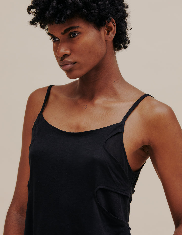 Cascading spaghetti strap tank in a layered, jet black tissue-weight jersey. Relaxed fit with a shaped hemline, finished with our classic logo screenprinted at center back neckline. Straps are adjustable. Model wears size S. 85% polyester, 15% rayon. Made in China.