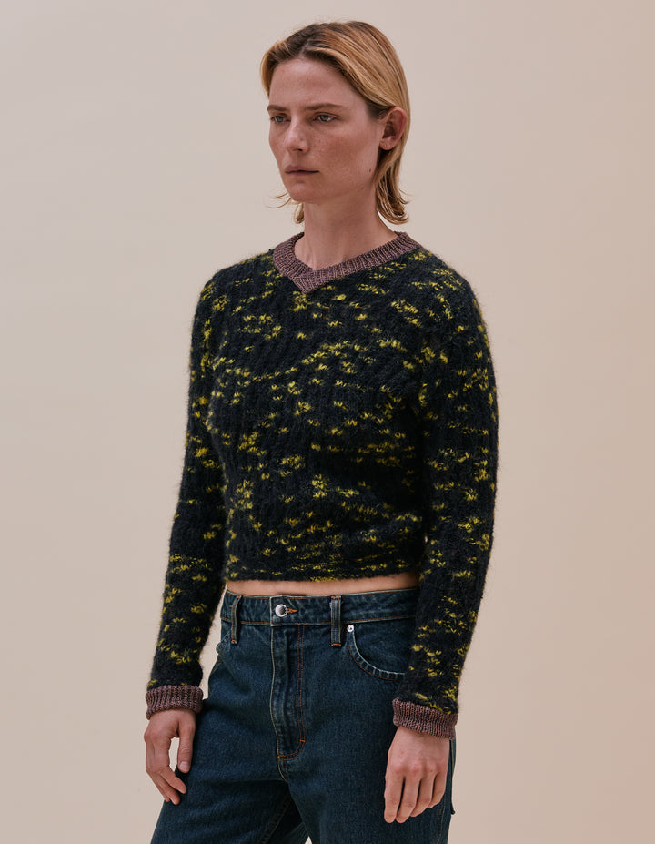 Fluffy and airy speckled V-neck sweater in a zig zagging racked rib with contrasting multicolor melange cotton trims. Model wears size M. Made in China. 15% Mohair, 14% wool, 44% polyacrylic, 15% polyamide, 10% cotton, 2% elastane.