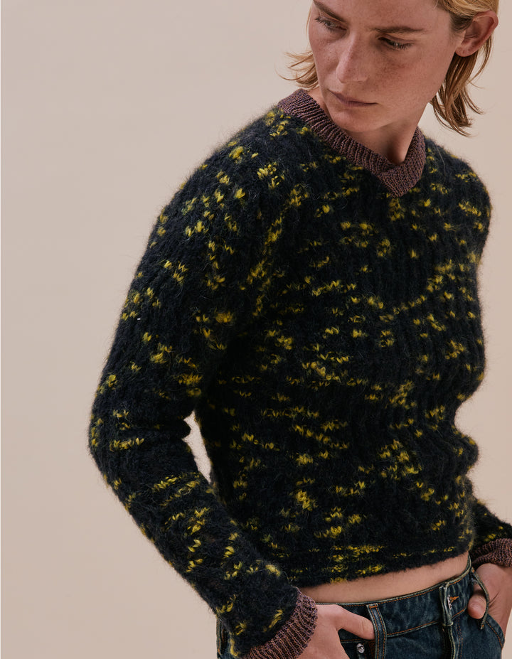 Fluffy and airy speckled V-neck sweater in a zig zagging racked rib with contrasting multicolor melange cotton trims. Model wears size M. Made in China. 15% Mohair, 14% wool, 44% polyacrylic, 15% polyamide, 10% cotton, 2% elastane.