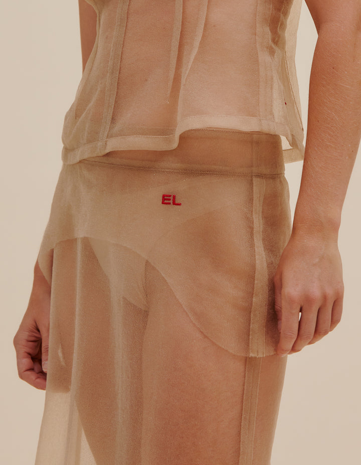 Straight fit, below-the-knee length skirt in a spongy Italian knit monofilament. Raw externalized facings at the waist with center back zip closure and vent. Embroidered “EL” logo on front left hip. Model wears size S. 100% nylon. Made in China.