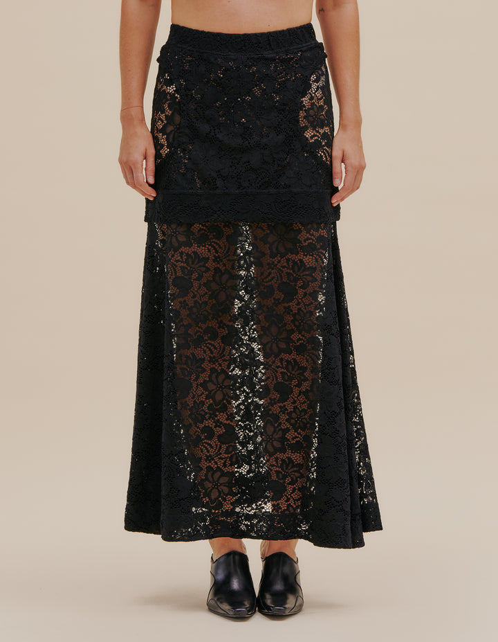 Double layered flared skirt in a semi sheer stretch floral lace. The top layer mini skirt is close-fitted to the body with side hip cutouts. Model wears size S. 90% Nylon, 10% Spandex. Made in China.