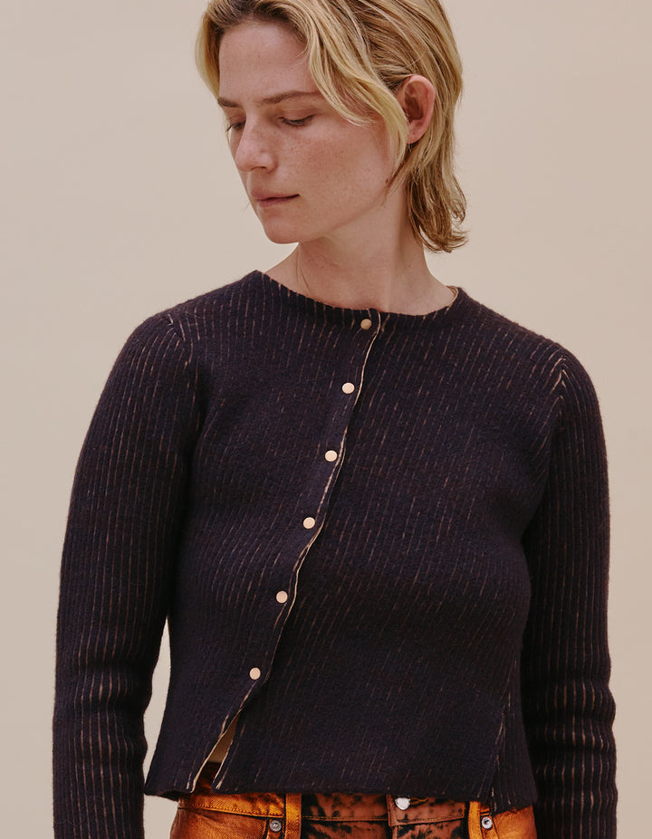 Slim cropped asymmetrical bias-knit cardigan in a substantial and stretchy luxe textile. Made from a felted melange wool, with nylon jacquard micro stripes. Fully fashioned knit with enamel contrast snaps. Model wears size S. Made in China. 70% wool, 30% nylon.