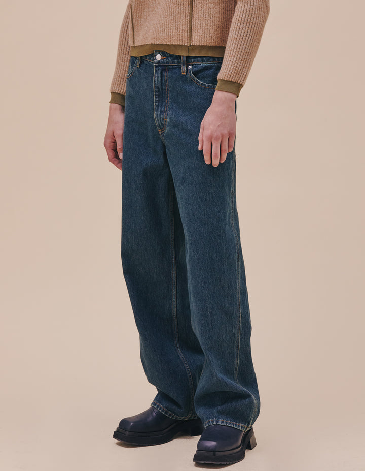 Our classic wide leg jean in our “New Blue” enzyme wash with over-dyed indigo. The jeans are distinguished with our trademark back patch pockets, and have a zip fly closure with a logo shank on the waistband along with rivets on the front pockets in nickel hardware. Models wear sizes 27 and 30. Made in USA. 100% cotton.