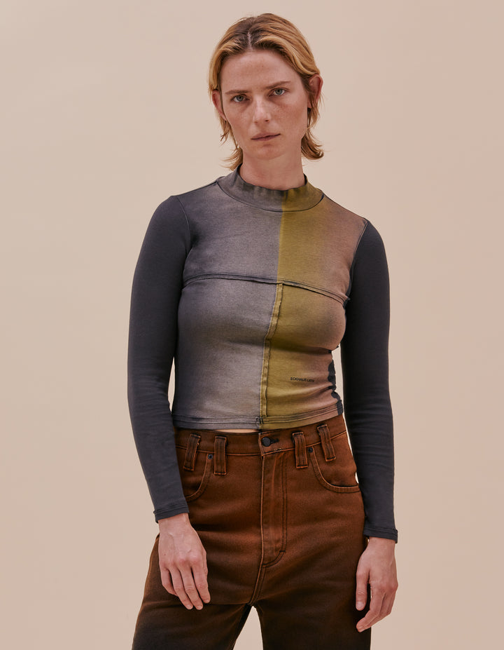 Our classic lapped baby turtleneck is cut in a 1x1 cotton baby rib. The top is broken up into multiple lapped pieces, raw edged seams are highlighted with topstitching. This version features the colorway "inky" with a hand dyed colorful gradient. Our classic mini logo is screen printed at the left abdomen. Model wears size small. Made in Peru. 100% cotton.
