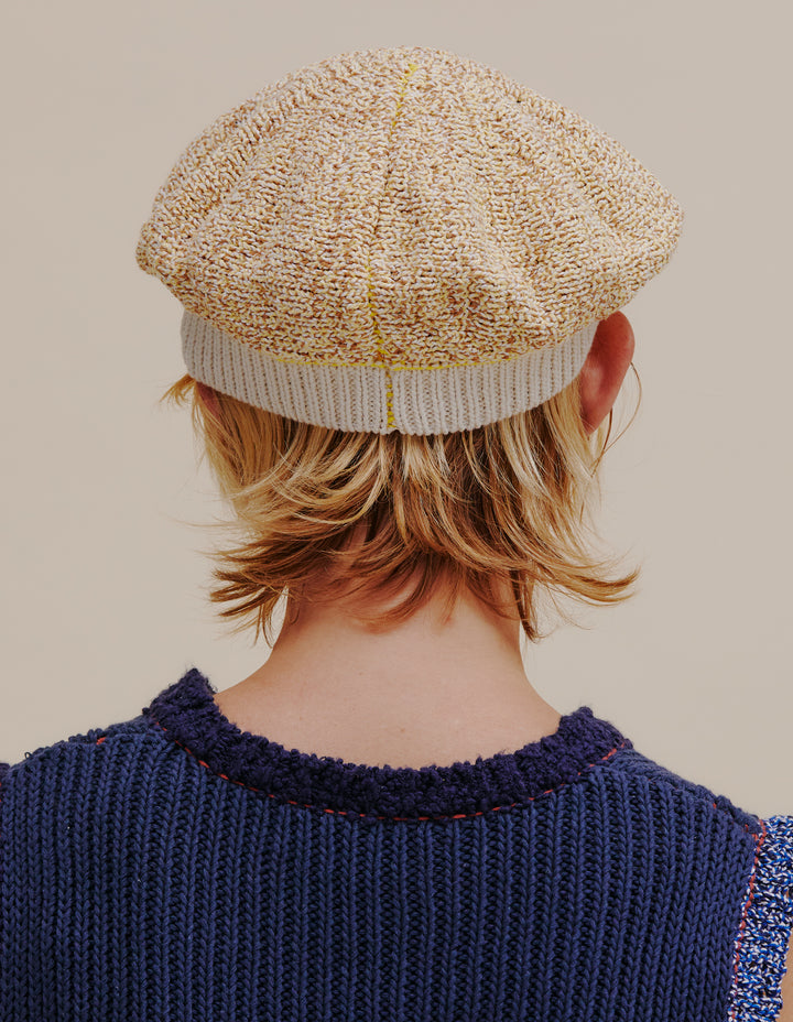 Fully fashioned knit beret made from a cotton and linen yarn blend. Contrast ribbed white band. Model wears OS. 49% cotton, 49% linen, 2% poly. Made in China.