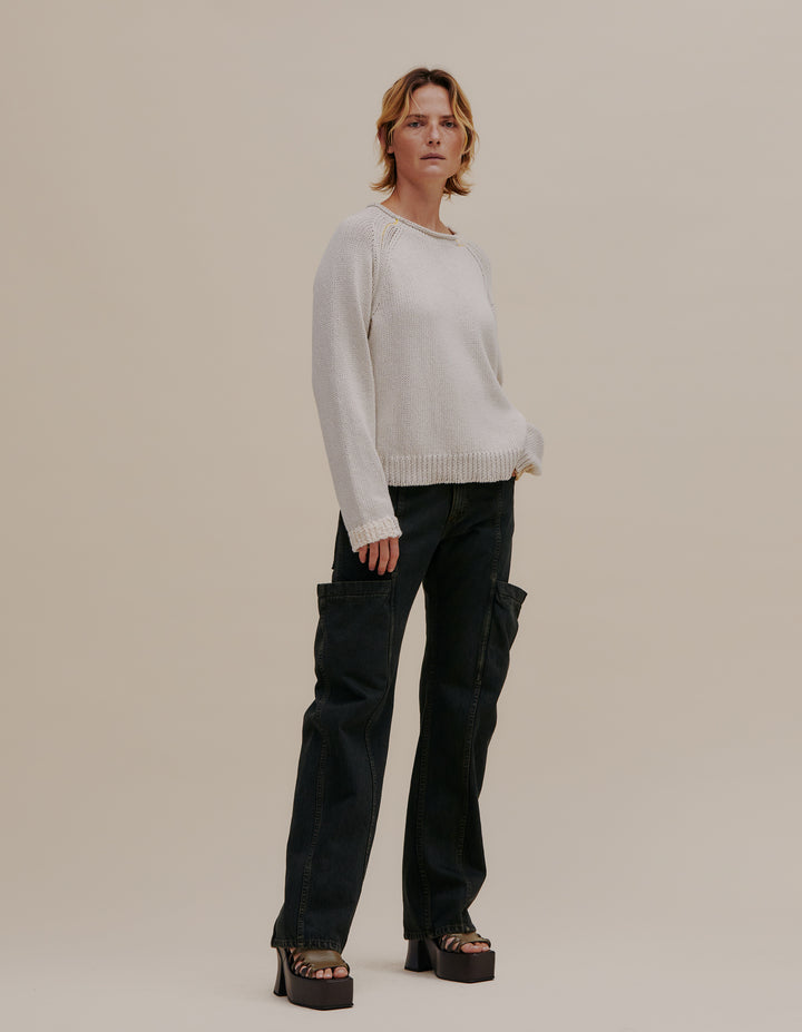 Raglan-sleeve ribbed sweater made from a cotton and linen yarn blend. Contrasting color patches around hem, neckline and cuffs. Funnel neck with novel yarn details. Models wear size M. 49% cotton, 49% linen, 2% poly. Made in China.