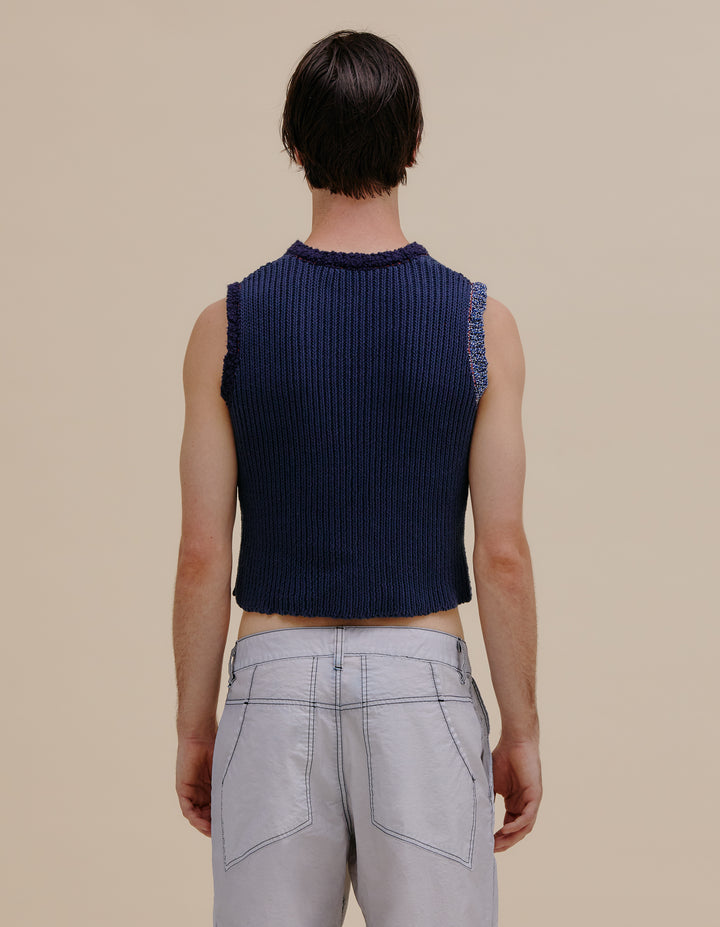 Ribbed crewneck vest made from a cotton and linen yarn blend. Contrasting color patch on torso and around arm holes. Models wear sizes S and L. 49% cotton, 49% linen, 2% poly. Made in China.