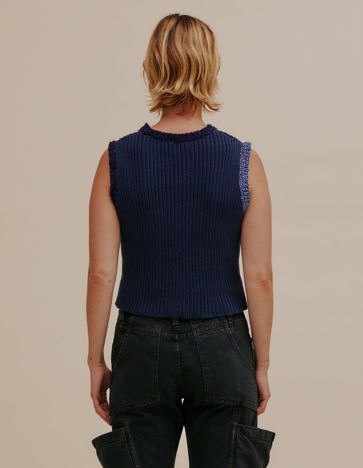 Ribbed crewneck vest made from a cotton and linen yarn blend. Contrasting color patch on torso and around arm holes. Models wear sizes S and L. 49% cotton, 49% linen, 2% poly. Made in China.