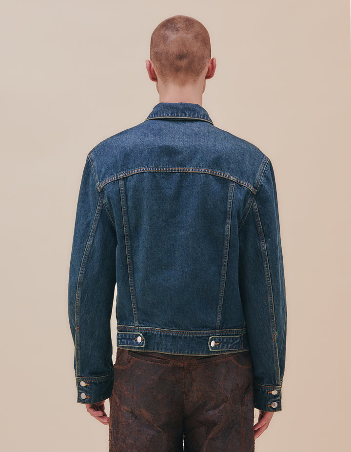 The newest addition to our denim collection, the EL jacket has a boxy, slightly cropped with with details that play on traditional denim finishing. This iteration featured our “New Blue” enzyme wash with over-dyed indigo. Finished with nickel hardware. Model wears a size M. Made in USA. 100% cotton.