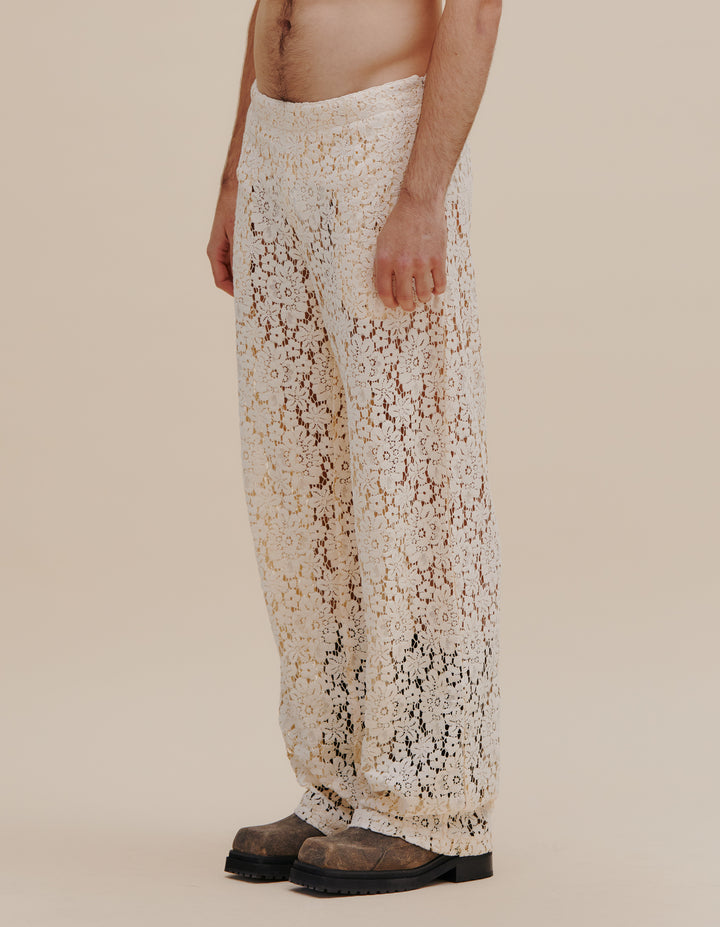 Italian floral lace pant with a detachable three-quarter length skirt layer, complete with an adjustable belt and slider. This pant has a natural rise with a straight leg and side seam pockets. Models wear size S. 55% cotton, 27% nylon, 18% viscose. Made in China. This style runs large, we suggest sizing down.