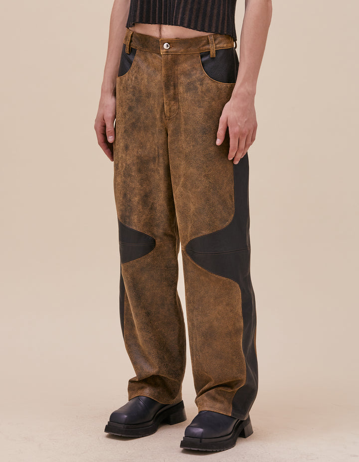 These pants are crafted in distressed deadstock leather hand selected in Portugal. Mid rise with a straight leg, semi lined. Curvilinear patchwork throughout the garment showcases the two distinct leather qualities. Made in Portugal. 100% leather, lining 100% polyester. Models wear sizes 27 and 30.&nbsp;