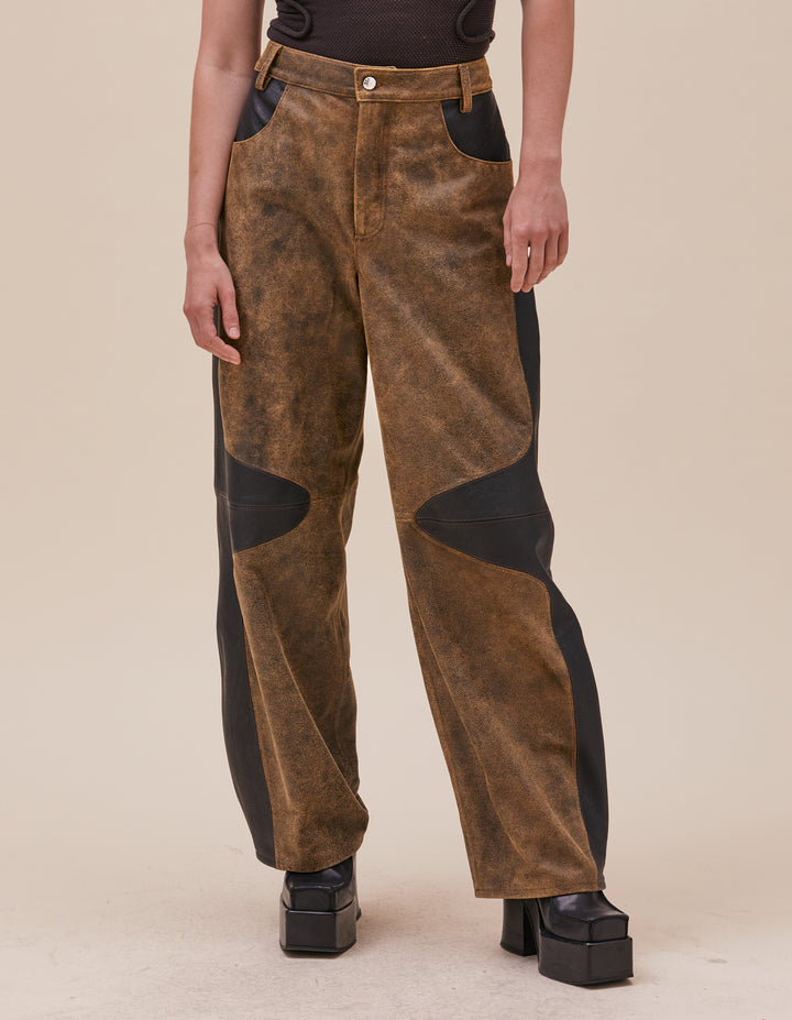 These pants are crafted in distressed deadstock leather hand selected in Portugal. Mid rise with a straight leg, semi lined. Curvilinear patchwork throughout the garment showcases the two distinct leather qualities. Made in Portugal. 100% leather, lining 100% polyester. Models wear sizes 27 and 30.