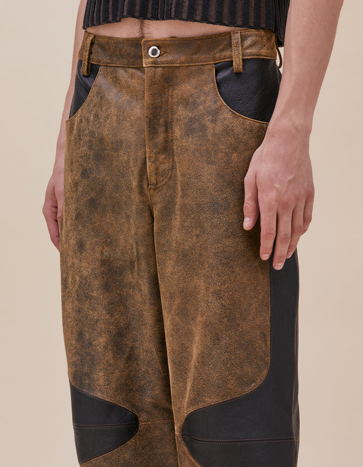 These pants are crafted in distressed deadstock leather hand selected in Portugal. Mid rise with a straight leg, semi lined. Curvilinear patchwork throughout the garment showcases the two distinct leather qualities. Made in Portugal. 100% leather, lining 100% polyester. Models wear sizes 27 and 30.&nbsp;