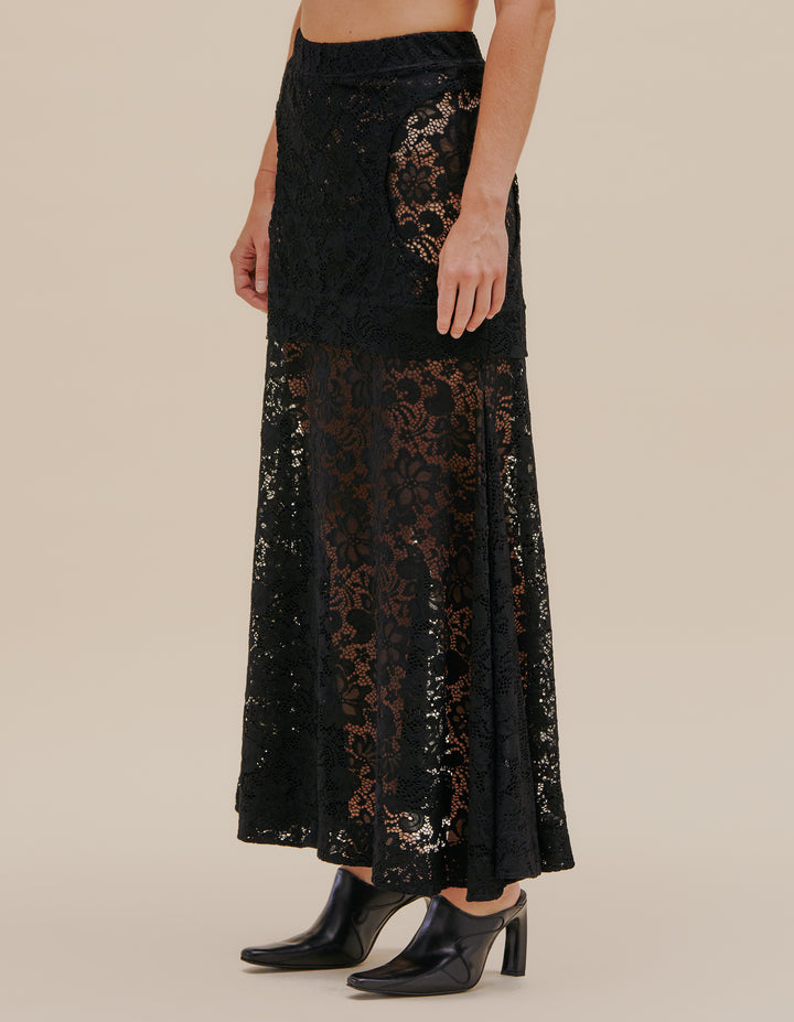 Double layered flared skirt in a semi sheer stretch floral lace. The top layer mini skirt is close-fitted to the body with side hip cutouts. Model wears size S. 90% Nylon, 10% Spandex. Made in China.