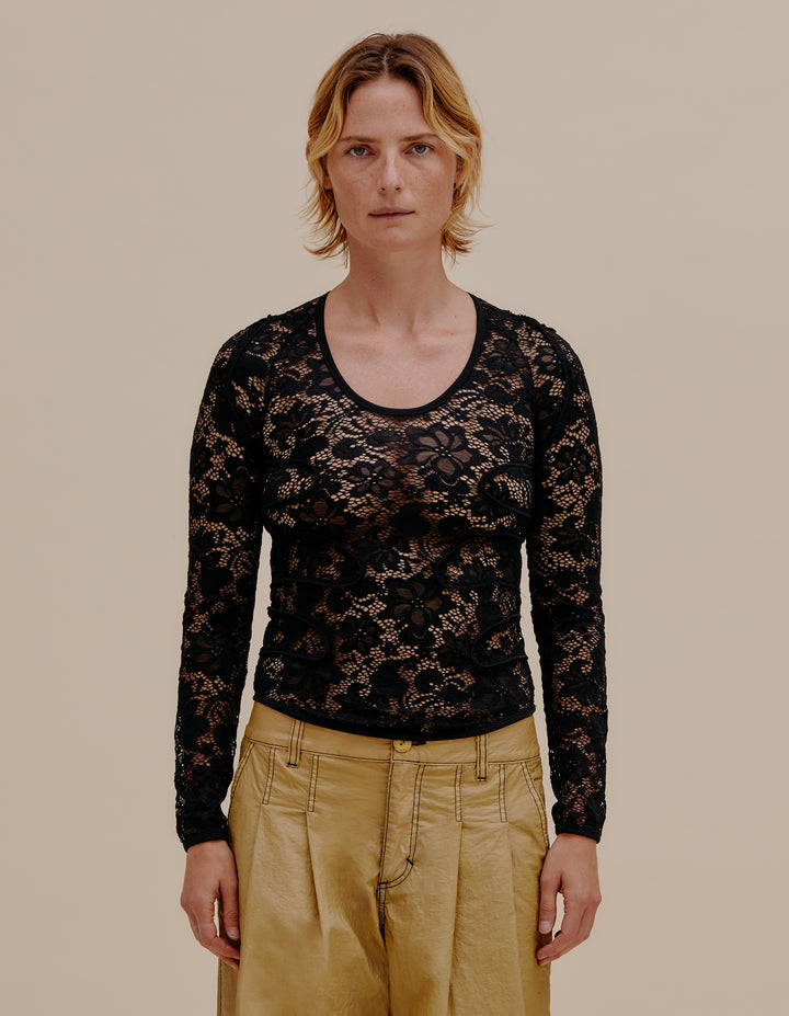 Fitted, scoop-neck long sleeve in a semi sheer stretch floral lace. Contouring curvilinear piping details on shoulders and torso. Model wears size S. 90% Nylon, 10% Spandex. Made in China.